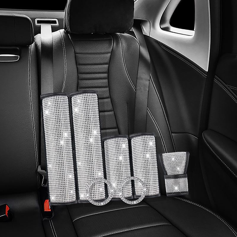 Diamond Luxe Crystal Car Kit installed on black leather car seats, showcasing 7-piece luxury bling accessories for seat belts and interior trim.