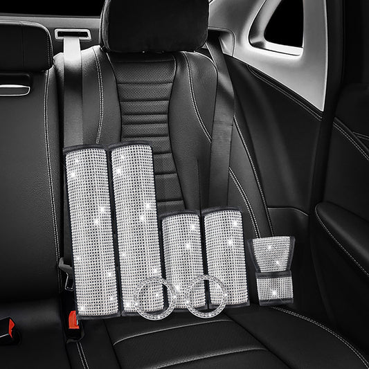Diamond Luxe Crystal Car Kit installed on black leather car seats, showcasing 7-piece luxury bling accessories for seat belts and interior trim.