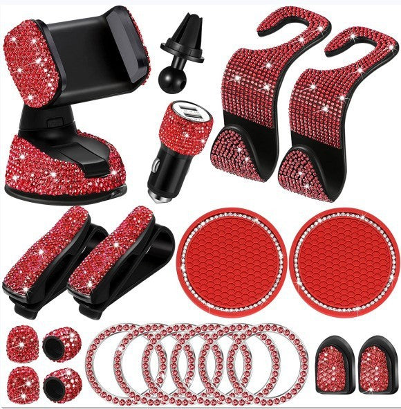 Collection of car accessories with red and black design, including phone holder, coasters, and hangers.