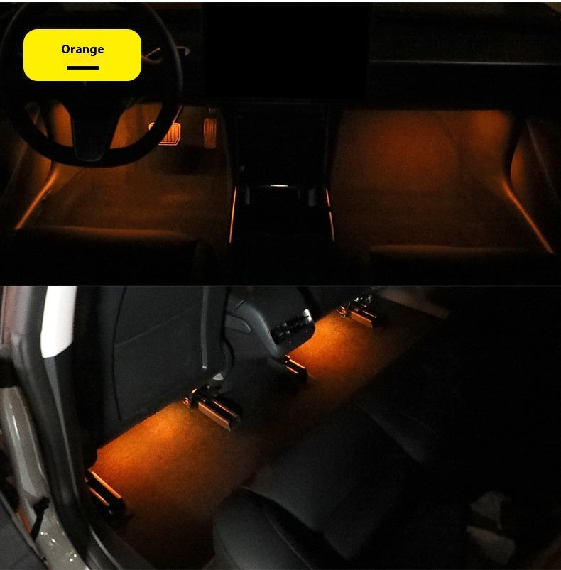 Magnetic Ambient Module displaying orange LED ambient lighting in car footwell and rear seats