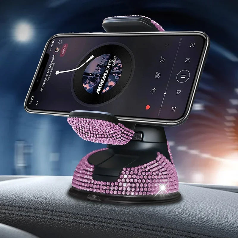 Pink crystal rhinestone phone holder with suction cup base on car dashboard