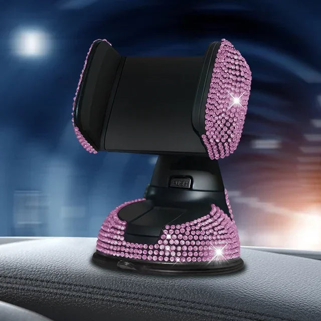 Pink crystal rhinestone phone holder with suction cup base on car dashboard